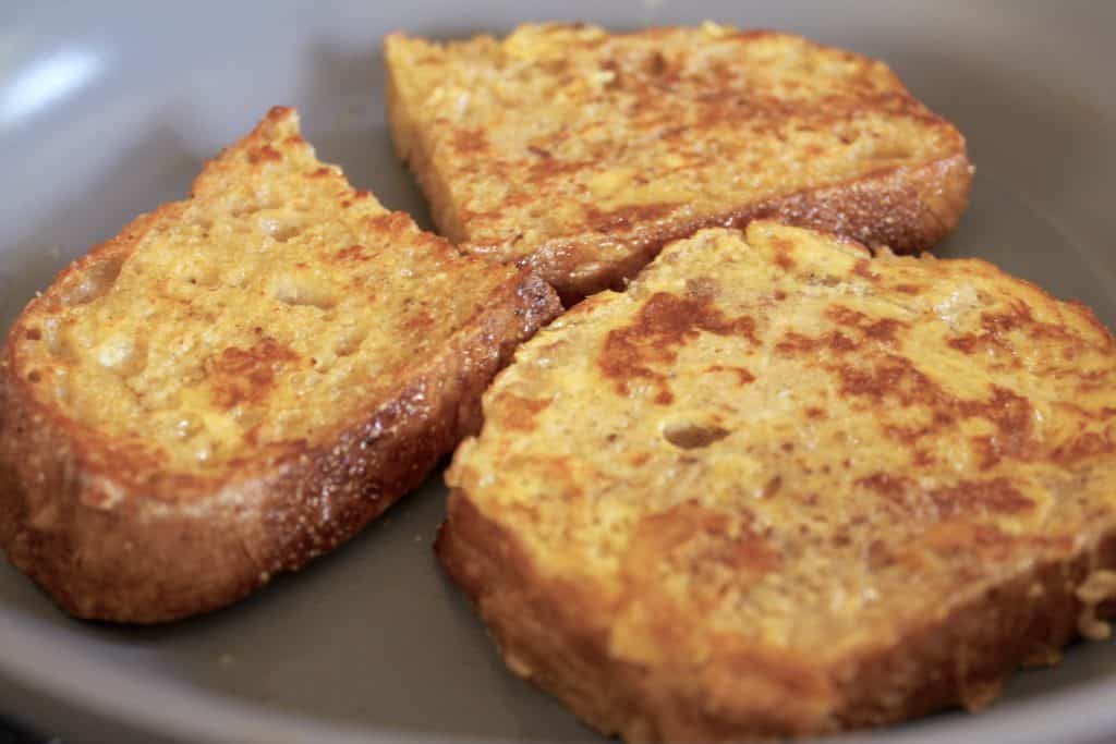 cooking overnight french toast in a pan