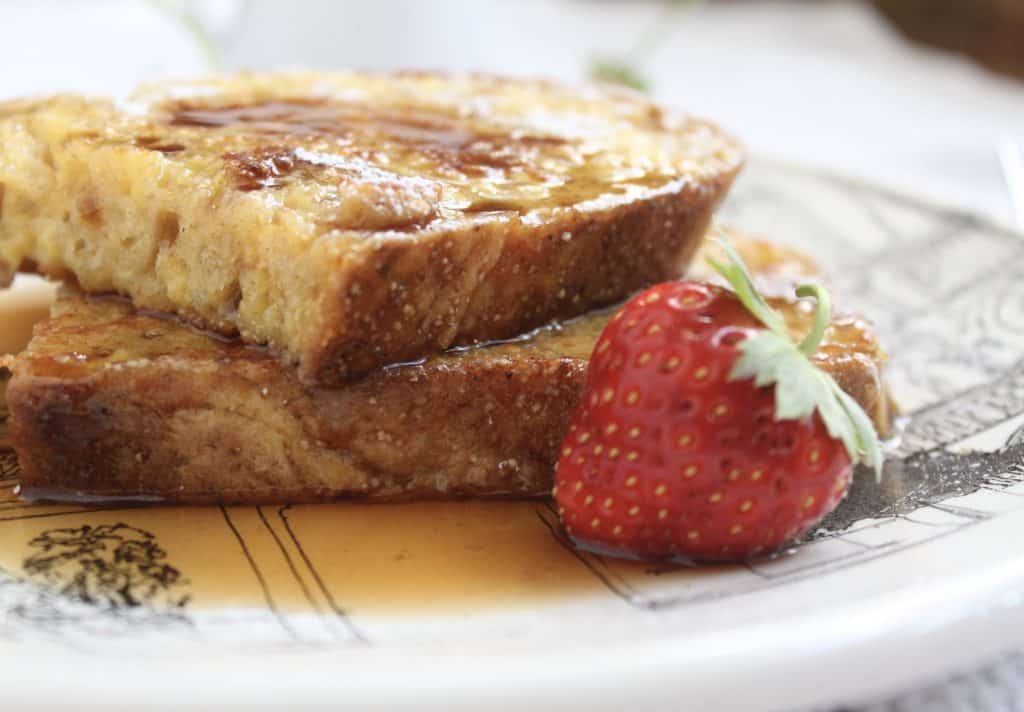 overnight french toast on a plate with a strawberry