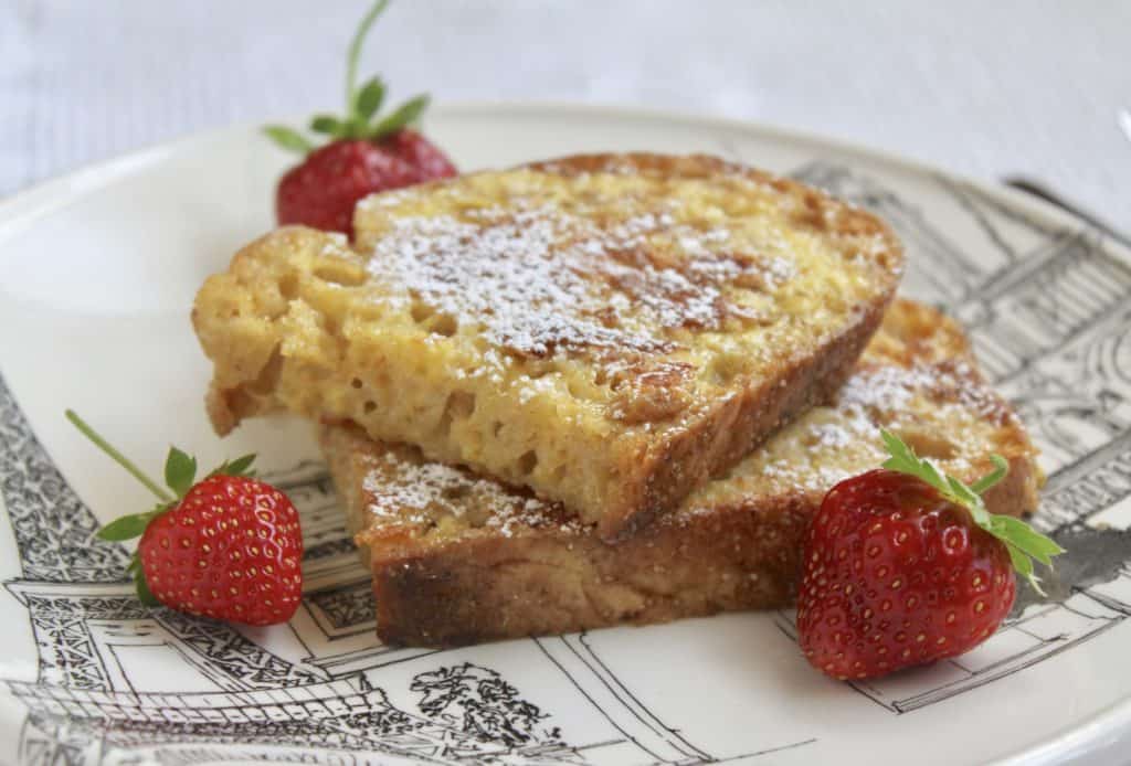 Overnight French Toast with powdered sugar and strawberries