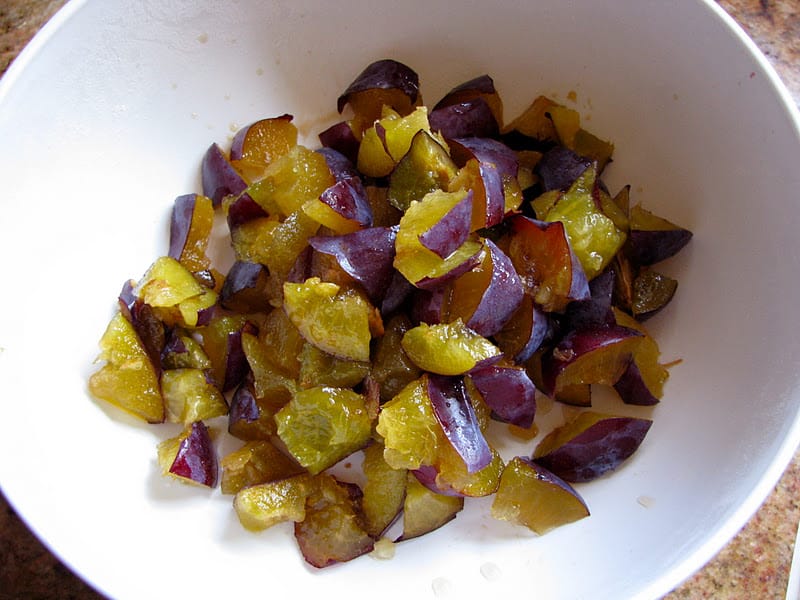 cut plums in a bowl