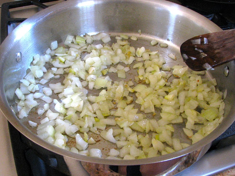 sauteeing chopped onion in a large pan