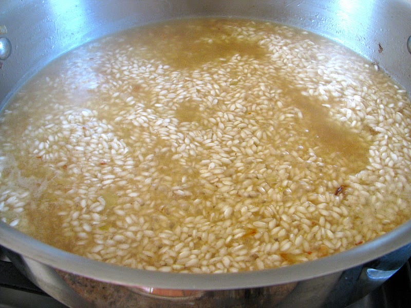adding the liquid to the rice