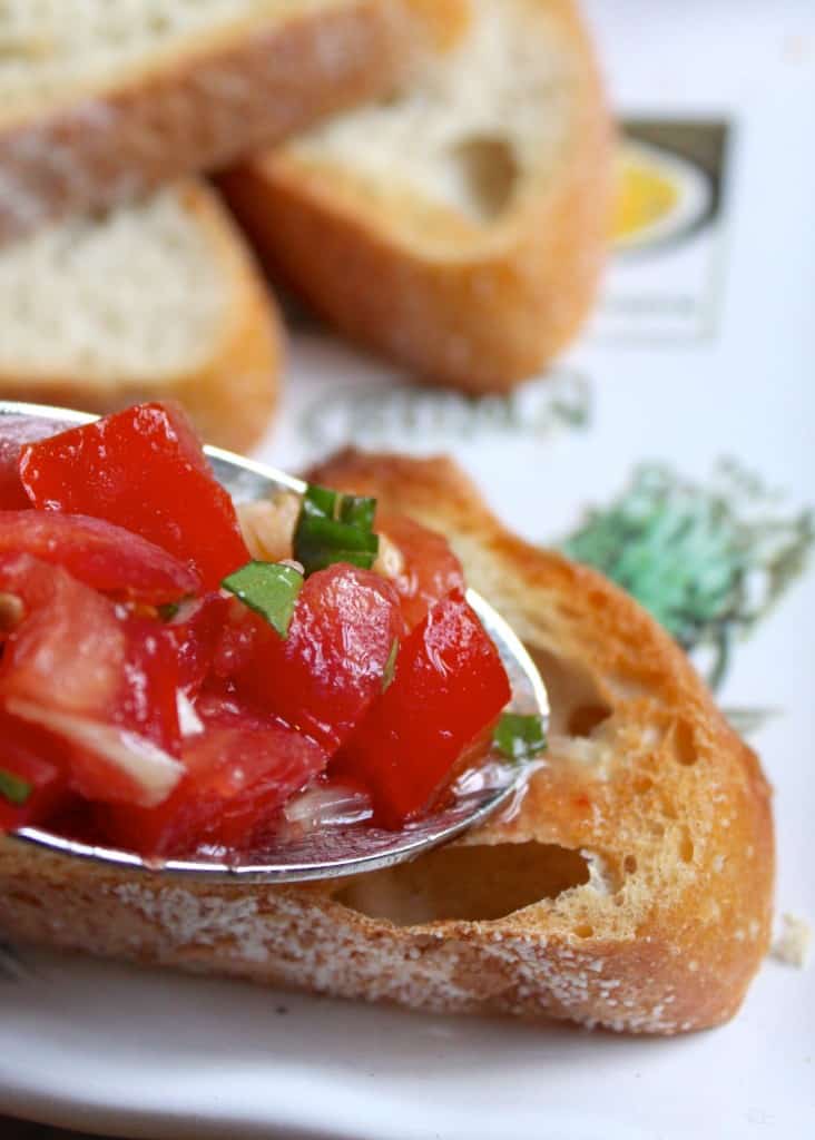 topping toast with the tomato mixture to make bruschetta