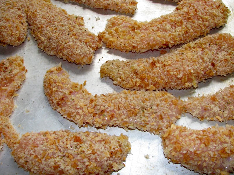 breading on fingers on a tray