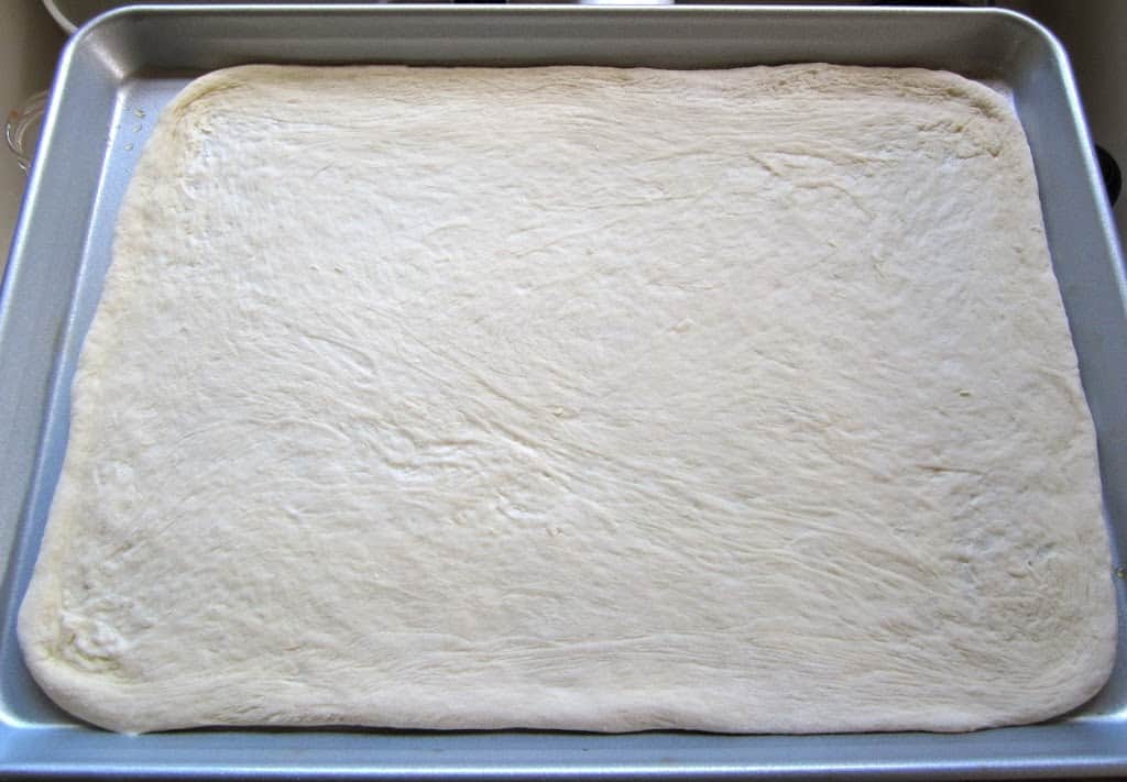 pizza dough on a cookie sheet