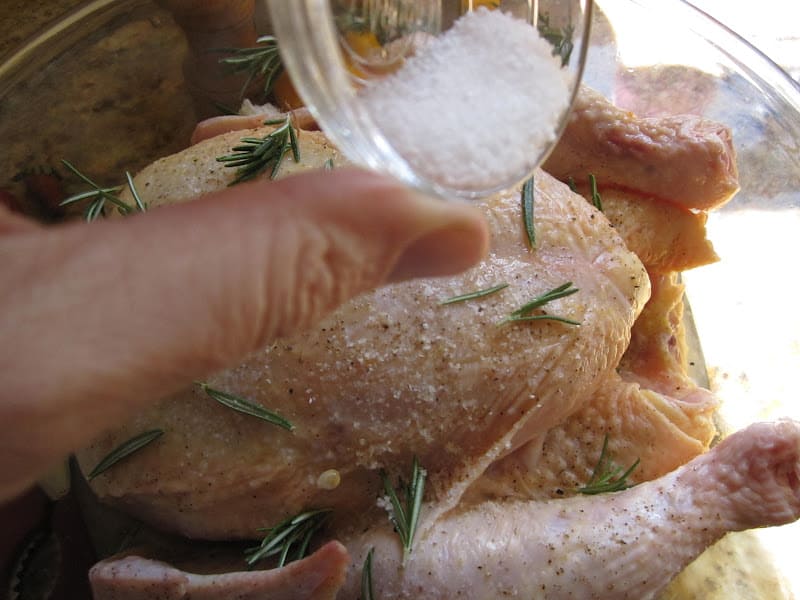 adding salt to rosemary citrus roast chicken