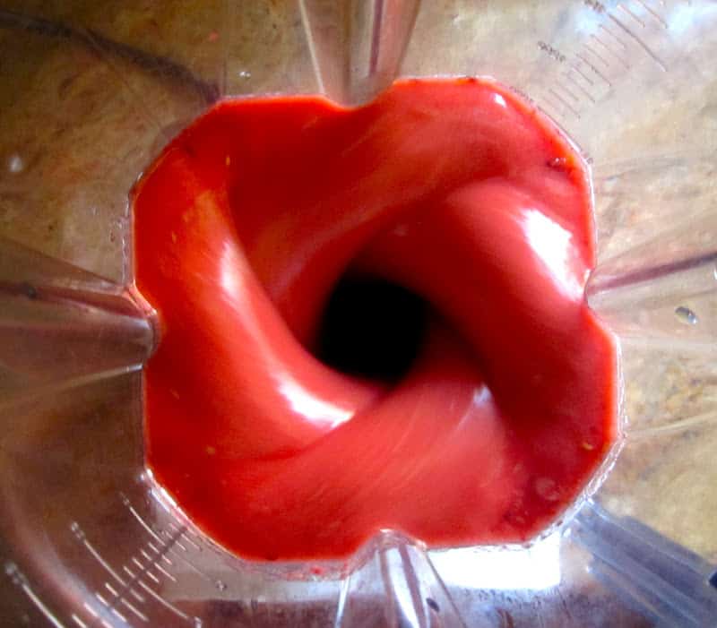 red fruit blending in a blender