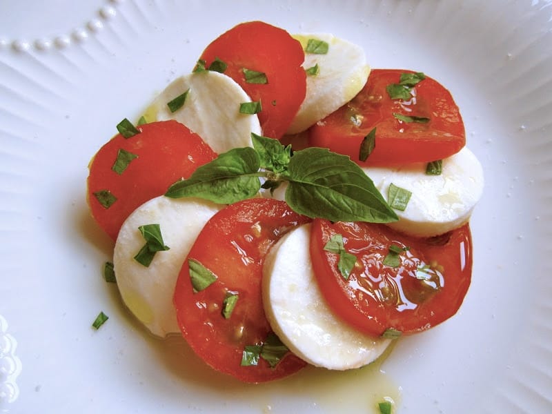 making mozzarella and tomato caprese salad