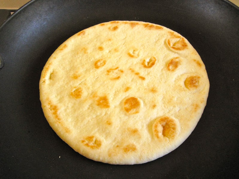 warming pita bread in a pan