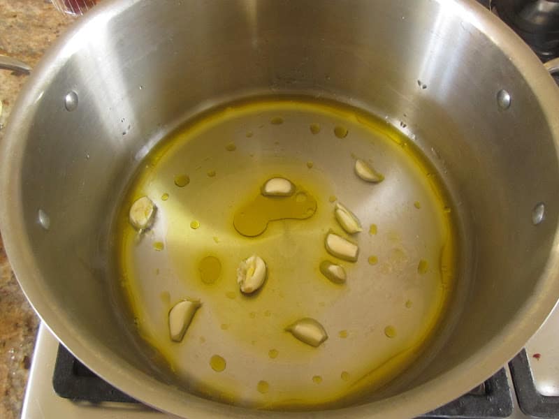 pot with water, oil and garlic in it