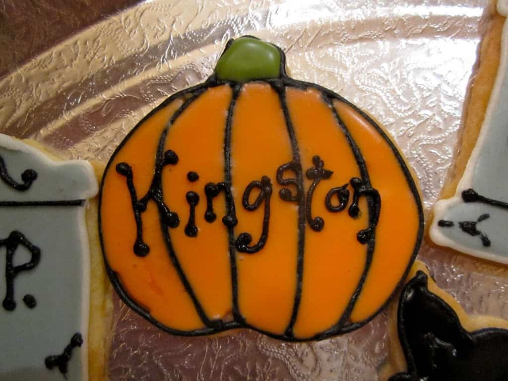 personalized pumpkin cookie with Kingston iced on it