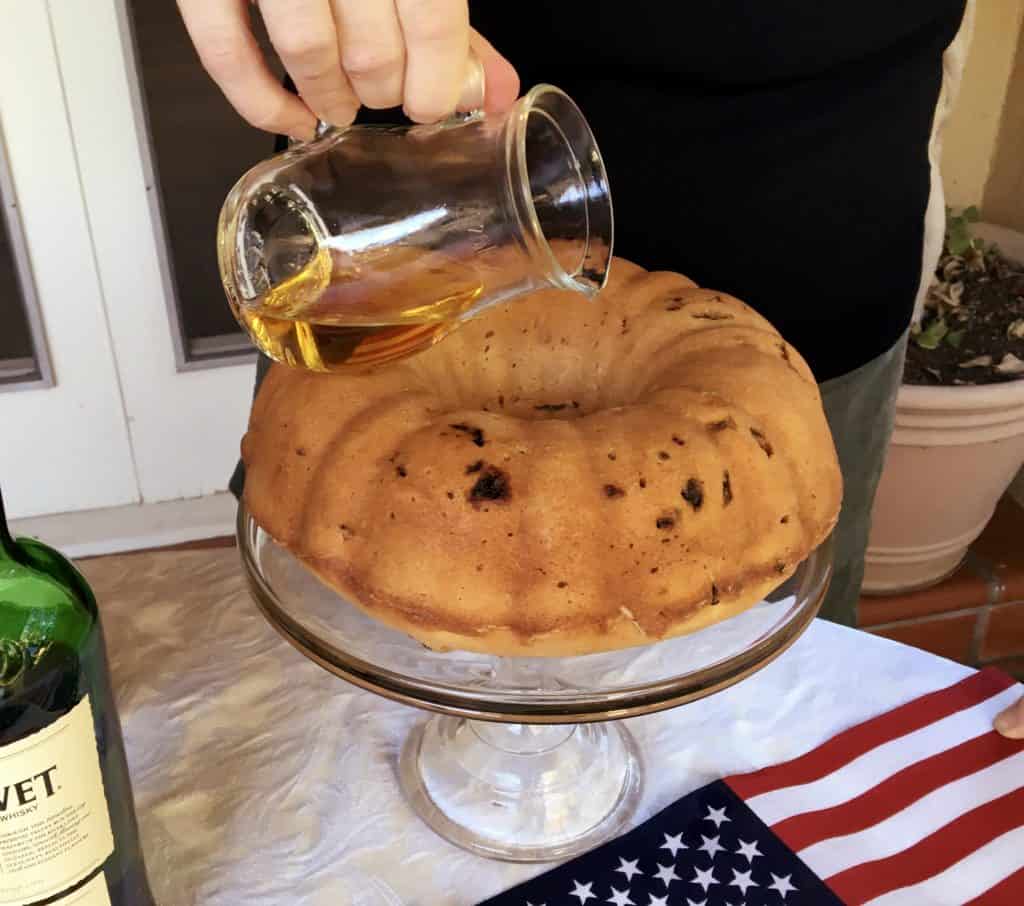 Drizzling Election Cake with one cup of whisky
