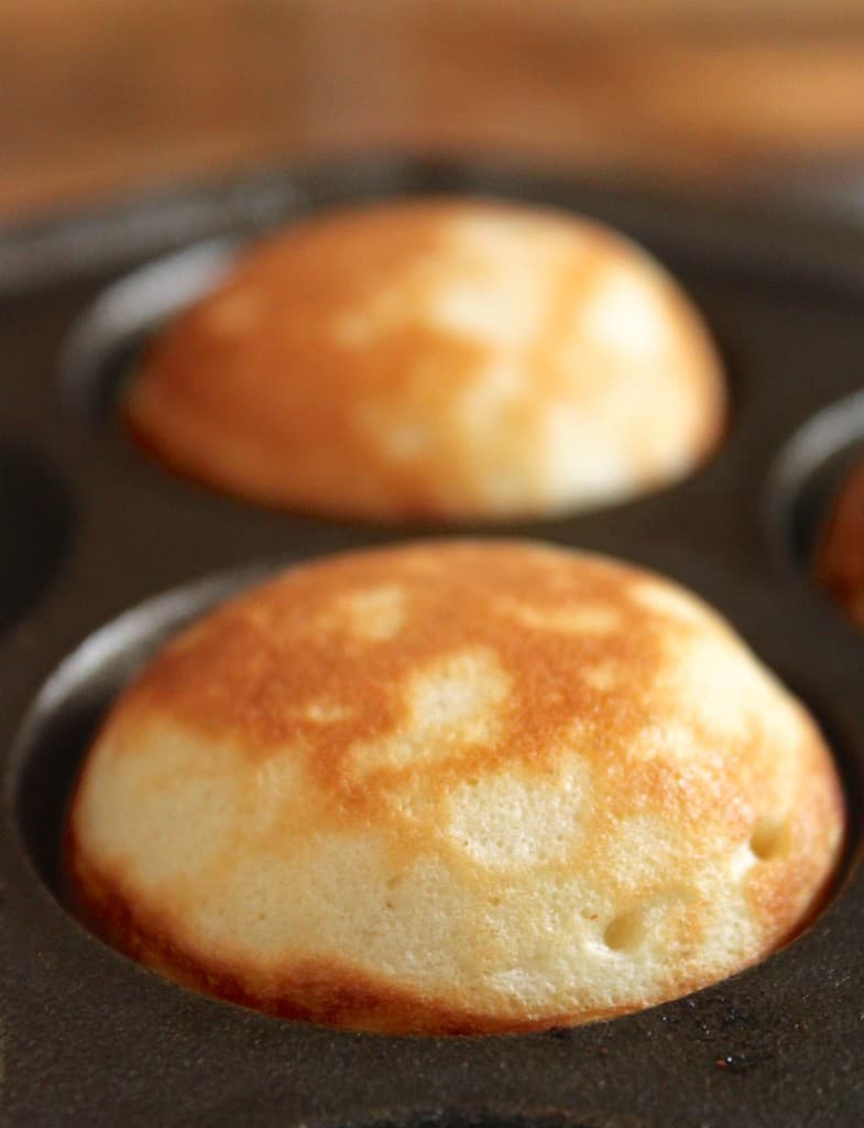 aebleskivers in a cast iron pan 
