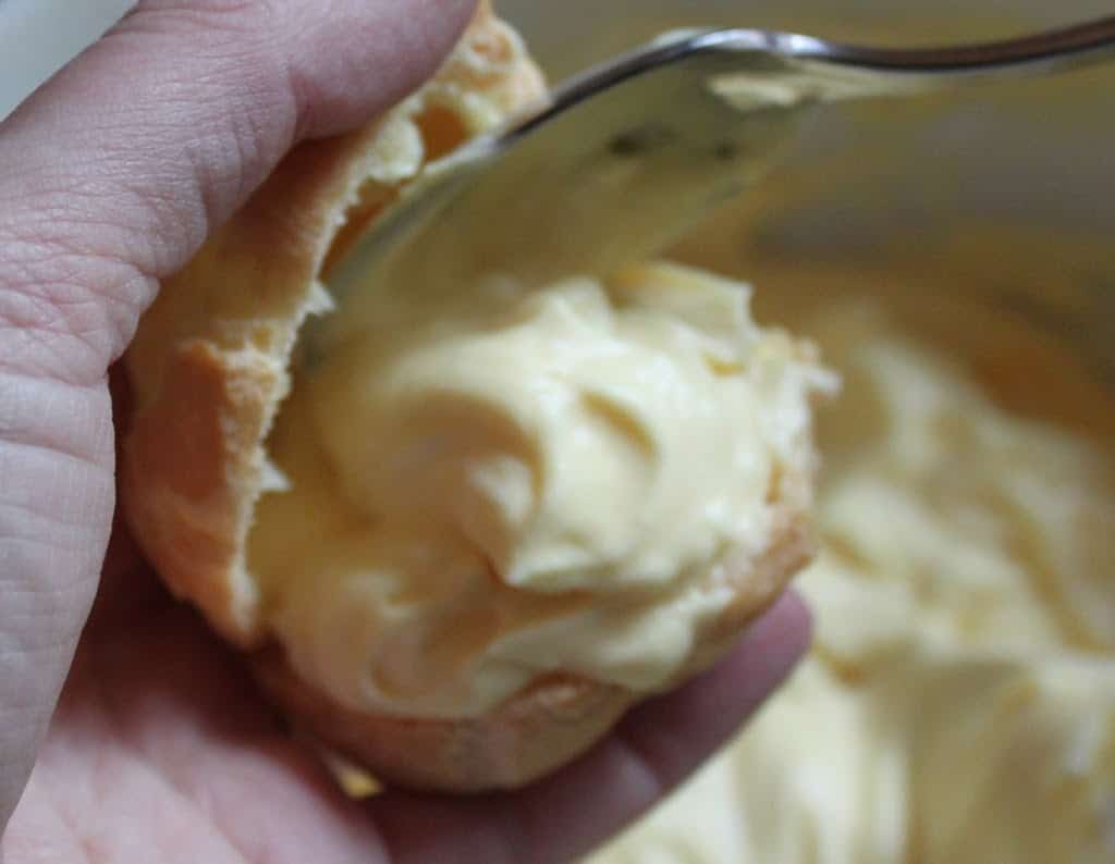 cream puff being filled with custard