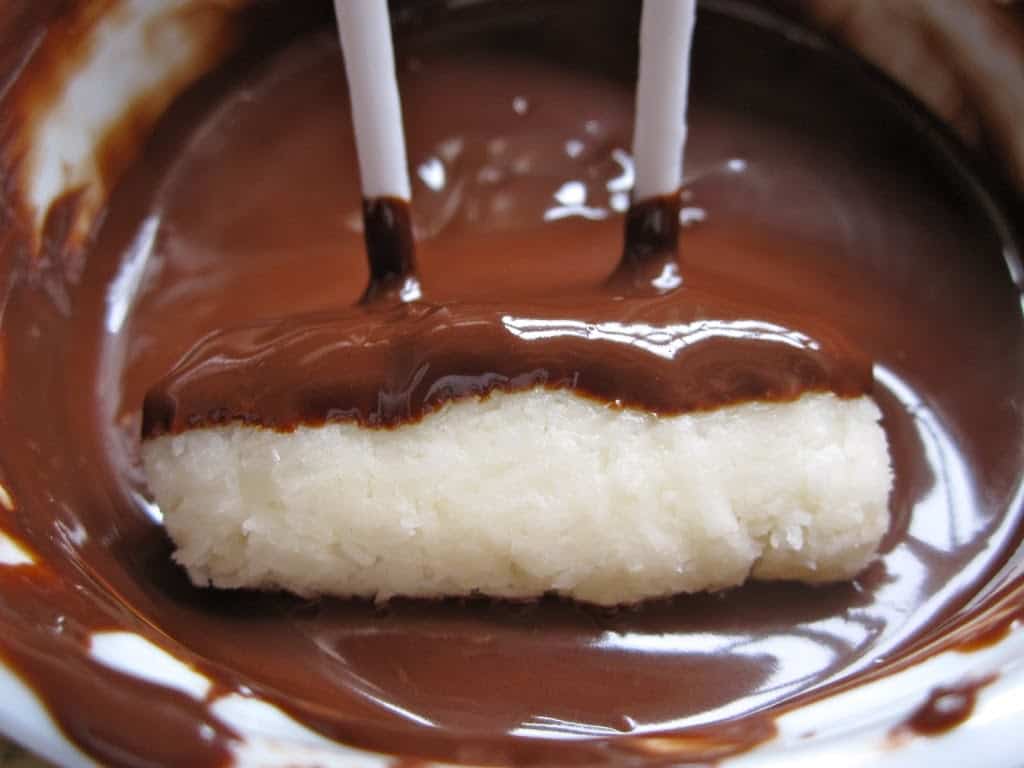 dipping coconut candy in chocolate