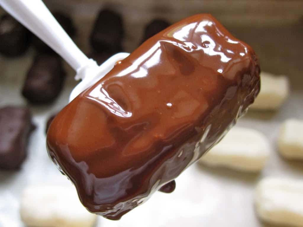 coconut candy in melted chocolate