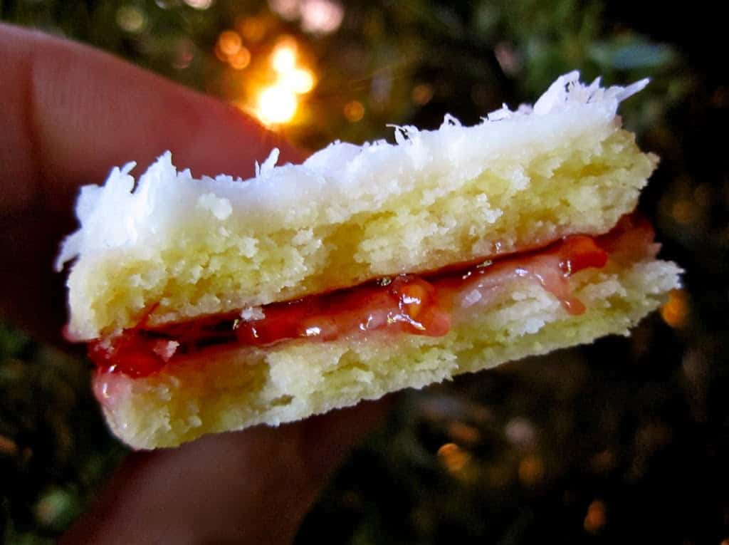 inside of a half eaten snow cookie showing oozing jam
