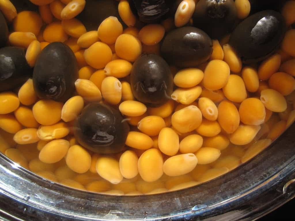 adding salt and olives to lupini beans