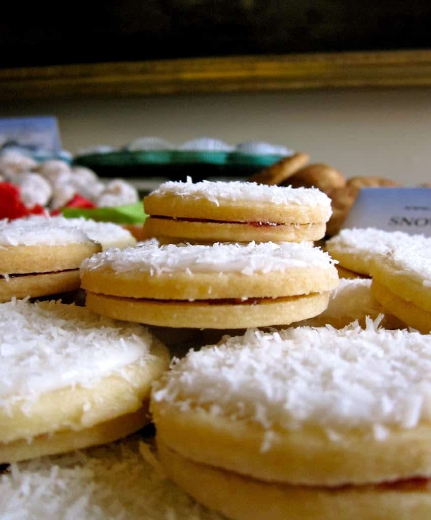 snow cookies stacked on a plate viewed from the side