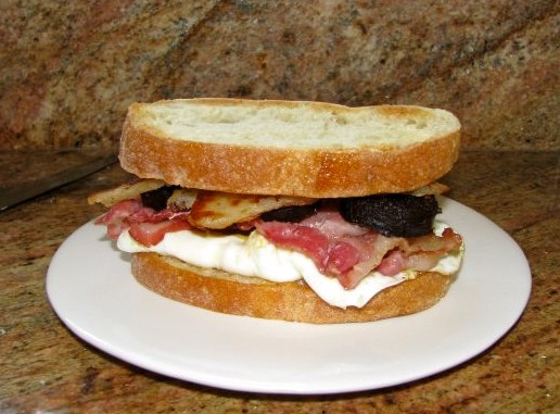 egg, bacon, black pudding and potato scone sandwich