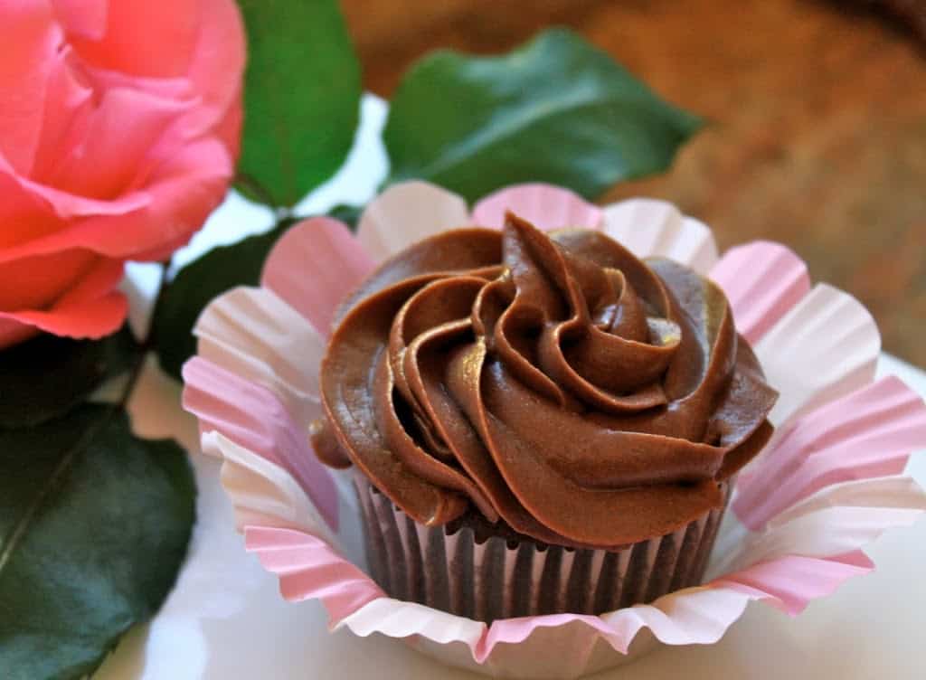 perfectly frosted buttermilk chocolate cupcake with a pink rose