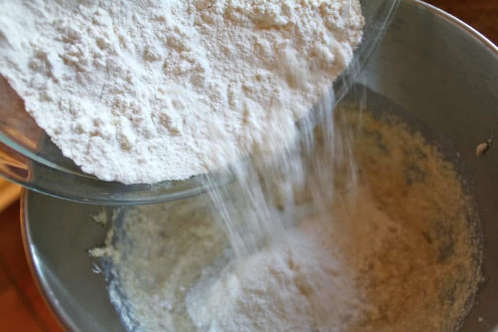 adding flour to the cake batter