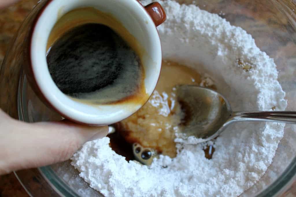 adding espresso to sugar to make icing