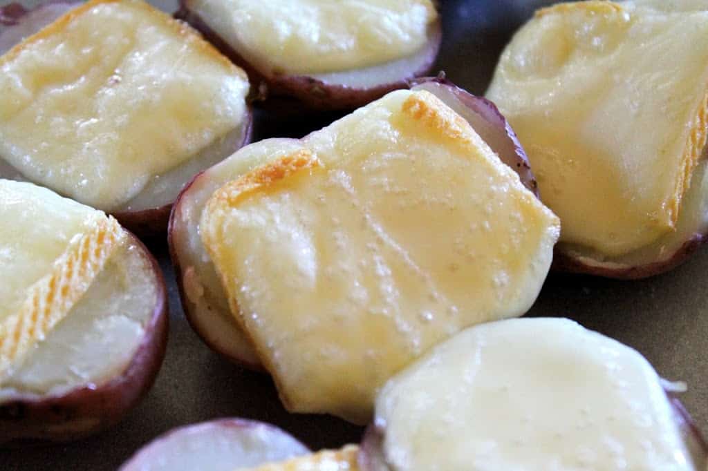 cut potatoes with melted cheese on top
