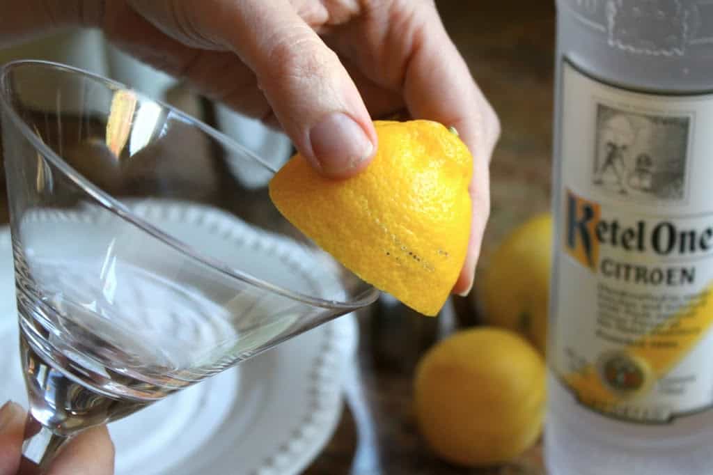 rimming a martini glass with lemon juice