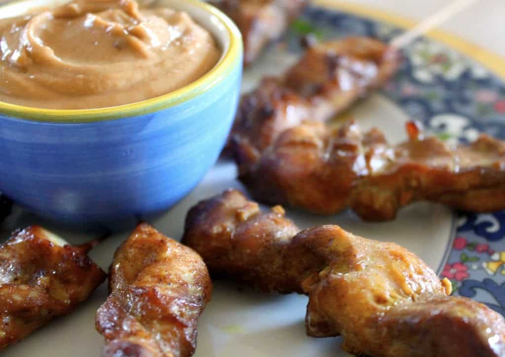 chicken skewered dipped into peanut sauce.