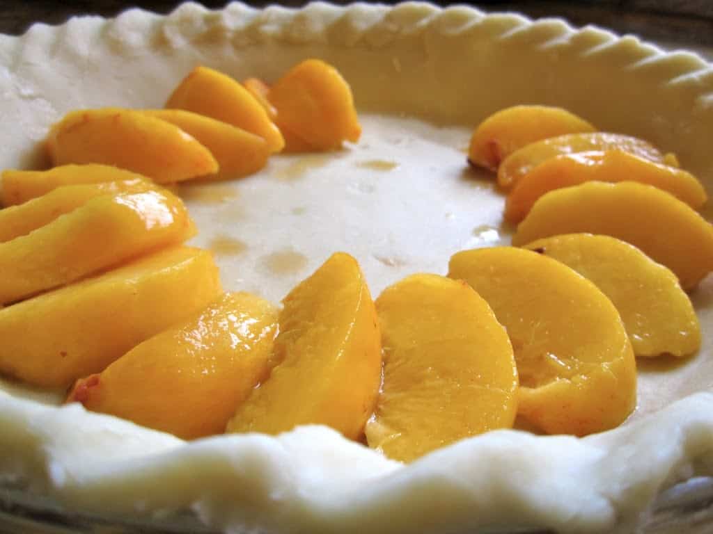 fresh peaches in raw pie crust