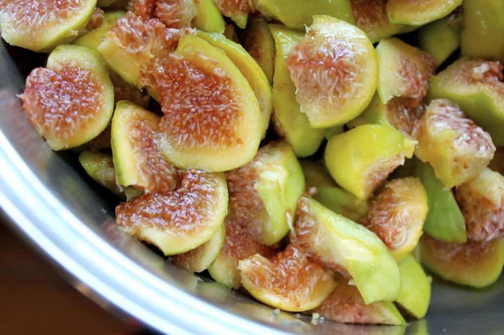 cut up figs for orange fig jam in a pot