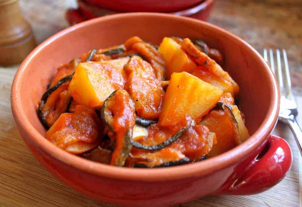 dried zucchini, pancetta and potatoes in a red bowl