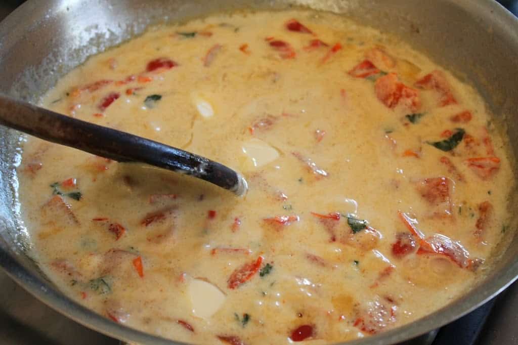 stirring sauce in a pan