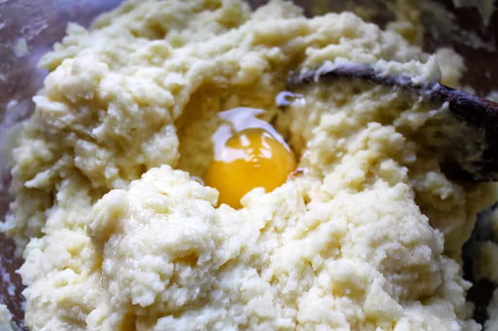 adding egg to potato mixture