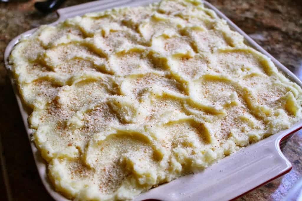 cheesy potato casserole with ham ready to bake