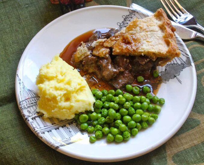 Steak pie with peas, potatoes and gravy