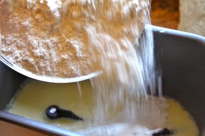 adding flour to liquid in bread machine