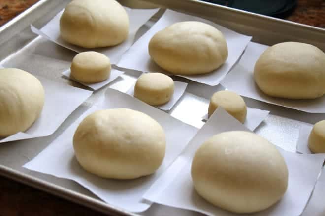 making perfect yeast doughnuts recipe rising on tray