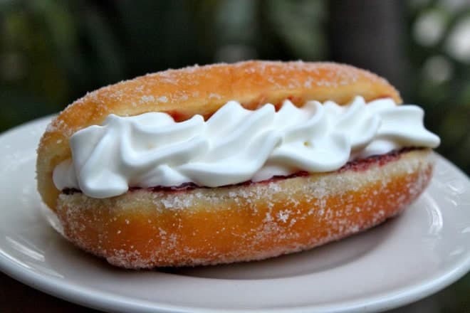 Long yeast sugar donut filled with jam and cream