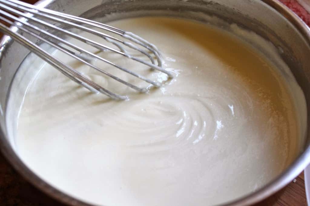 stirring melted goat cheese and cream in a pot