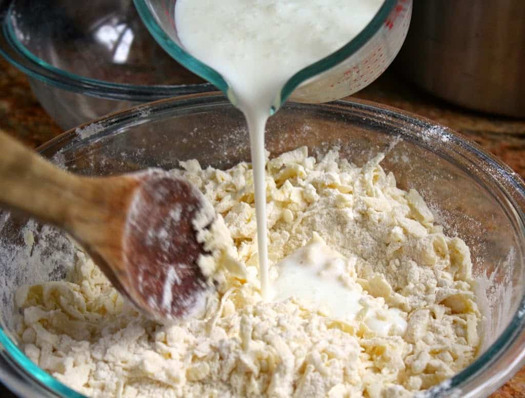 adding buttermilk to potatoes