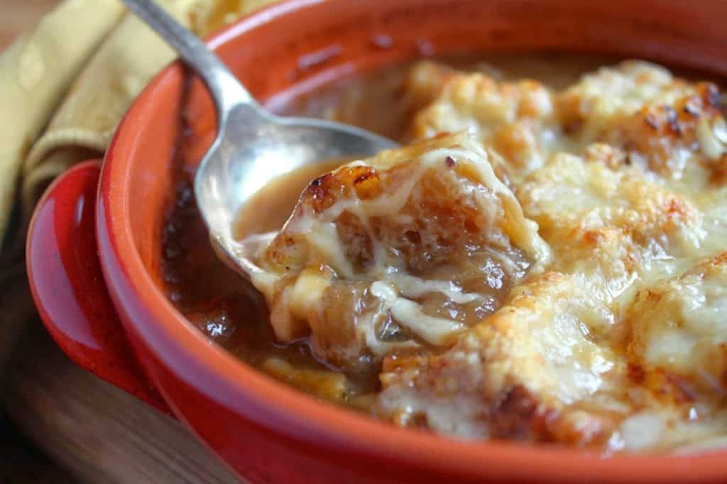 spoonful of French Onion Soup with melty cheese