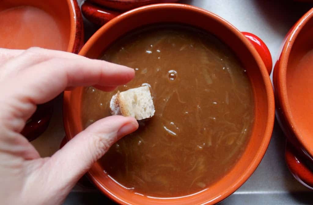 adding bread cubes to soup