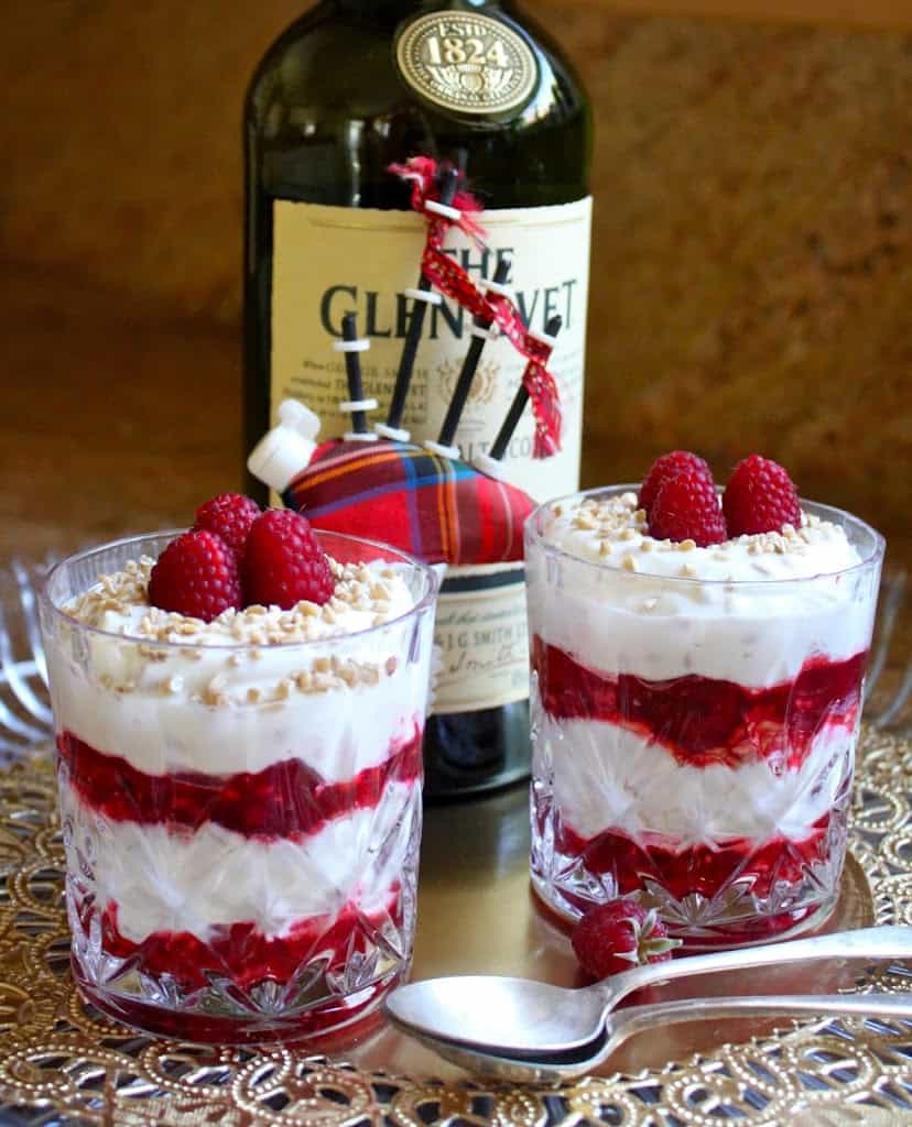 Cranachan in two crystal glasses and a bottle of whisky
