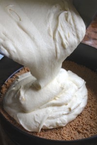 pouring filling onto crust in pan