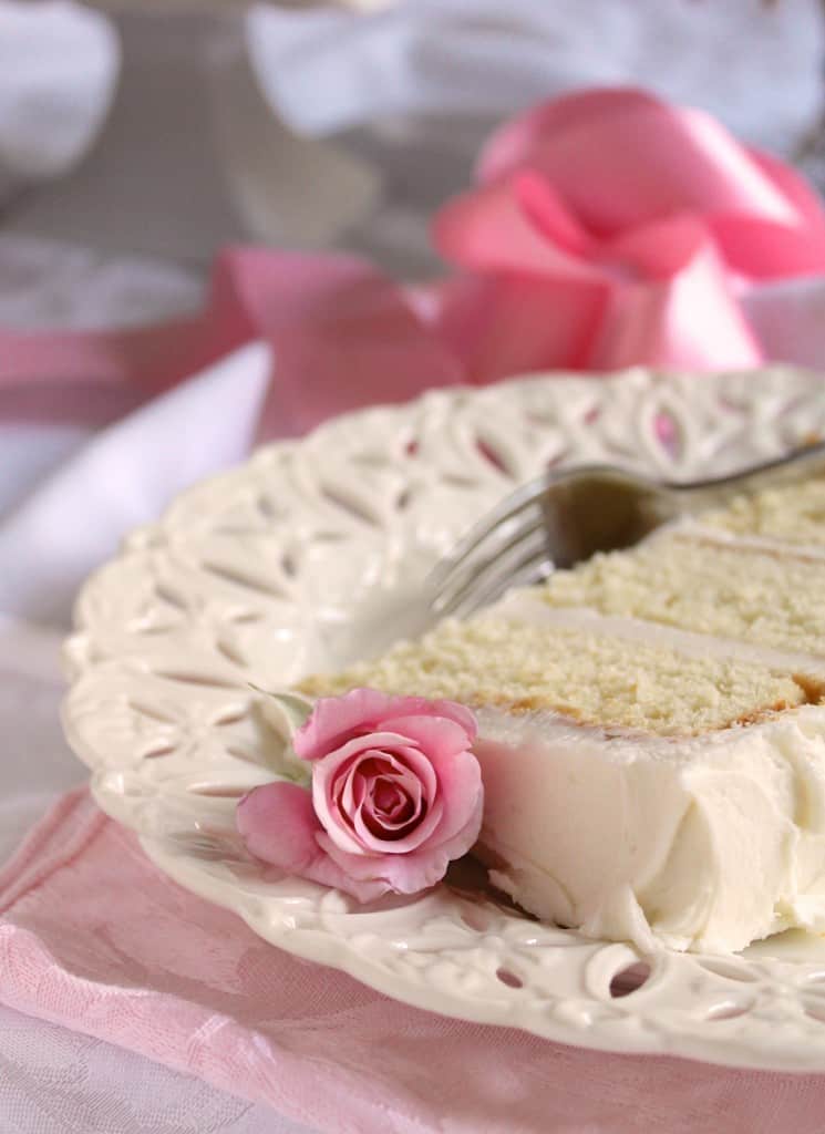 Slice of white cake with rosebud 
