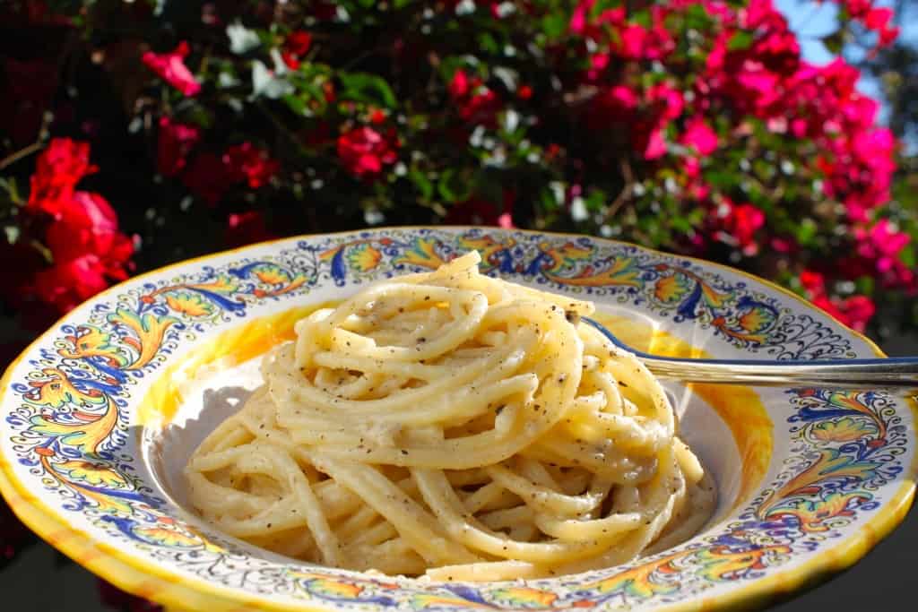 Cacio e pepe spaghetti in LA in front of bougainvillea