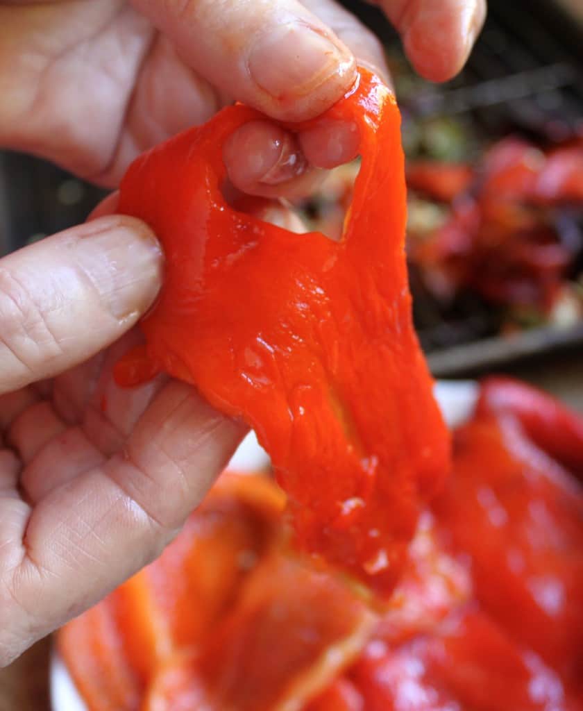 tearing roasted red peppers into strips