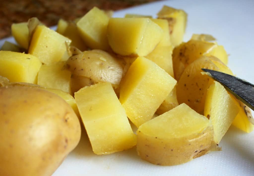 chopping yellow Idaho potatoes 